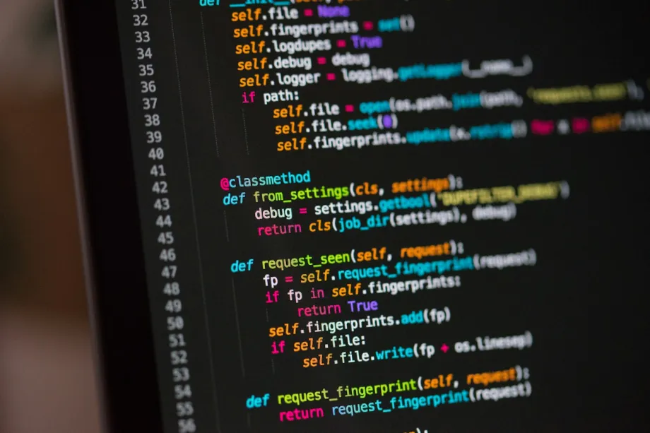 Computer screen showing colorful source code in a dark editor theme