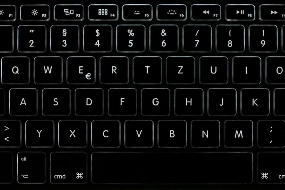 Close-up of a black computer keyboard in low light